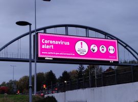 Salford overpass, coronavirus warning. Image credit: Matthew Lanceley