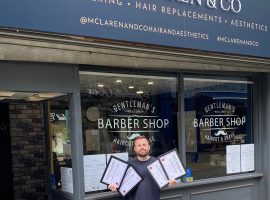 Ian McLaren holding his finalist certificates for the UK Hair and Beauty Awards 2023.  Photo courtesy of Ian McLaren.