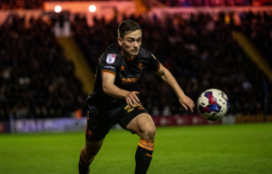 Luke Bolton chases the ball (Photo Salford City Twitter)