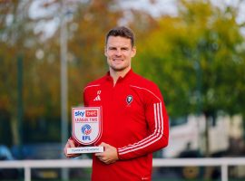 Matt Smith holding his October Player of the Month award. Credit: Salford City FC.