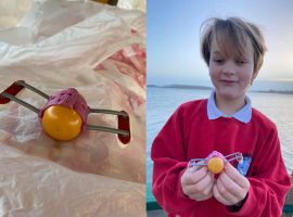 Toby, aged 8, after finding the toy time capsule that has been floating around the British seas for almost 25 years. Image via. Molly Petter on Facebook.