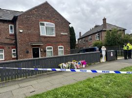 The police cordon in place outside the home in South Radford Street 
Images: Salford Now