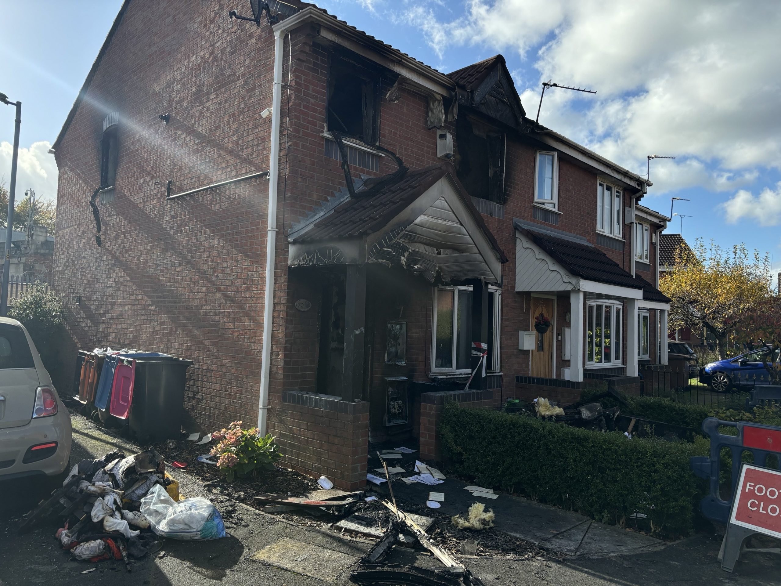 Salford house fire sees woman in 50s injured as investigation continues into cause