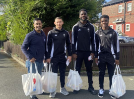 Abdulla Alamun, Kelly Nmai, Junior Luamba and Jon Taylor hand out food packages.