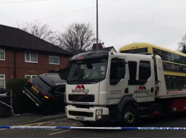 The car lodged into the bins after the crash. Photo credit: screenshot from @Helana Vesty, video on Twitter.