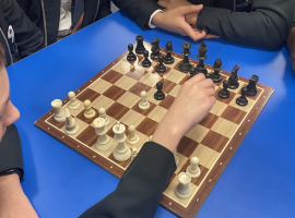 Students playing chess by Holly Fenton