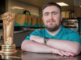Luke Littler with the trophy - Deliveroo