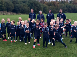 Dan Collins (left) trains one of Boothstown FC's youth teams.